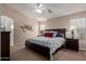 Comfortable bedroom featuring a ceiling fan, neutral walls, carpeted floor and a large bed with decorative pillows at 16280 W Durango St, Goodyear, AZ 85338