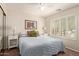 Relaxing bedroom with shuttered windows, carpet and a ceiling fan, enhancing comfort and natural light at 16280 W Durango St, Goodyear, AZ 85338