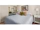 The bedroom features a queen bed, mirrored closet doors, and bright natural light, creating a welcoming atmosphere at 16280 W Durango St, Goodyear, AZ 85338