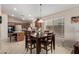 Cozy dining area features a wooden table set, pendant lighting, and a serene atmosphere for Gathering meals at 16280 W Durango St, Goodyear, AZ 85338
