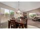 Dining room features wood table and chairs, fireplace and windows with blinds, creating a warm and inviting space at 16280 W Durango St, Goodyear, AZ 85338
