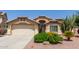 Charming home featuring a well-manicured front yard with desert landscaping, a two-car garage, and covered entryway at 16280 W Durango St, Goodyear, AZ 85338