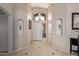 Bright foyer features tiled floors, high ceilings, decorative niches, and a beautiful chandelier at 16280 W Durango St, Goodyear, AZ 85338