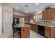Well-equipped kitchen with granite countertops, stainless steel appliances, and a functional center island at 16280 W Durango St, Goodyear, AZ 85338