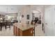 Spacious kitchen featuring an island with seating, wood cabinetry, and arched doorways at 16280 W Durango St, Goodyear, AZ 85338