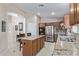 Well-equipped kitchen with granite countertops, stainless steel appliances, and a functional center island at 16280 W Durango St, Goodyear, AZ 85338
