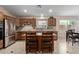Modern kitchen featuring stainless steel appliances, wooden cabinets, and granite countertops at 16280 W Durango St, Goodyear, AZ 85338