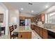 Open kitchen with stainless steel appliances, granite counters, and an island with bar seating at 16280 W Durango St, Goodyear, AZ 85338