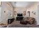 Cozy living room with neutral tones, a vaulted ceiling, and large windows providing natural light at 16280 W Durango St, Goodyear, AZ 85338