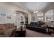 Spacious living room featuring archways, neutral tones, and comfortable seating perfect for relaxation and entertaining at 16280 W Durango St, Goodyear, AZ 85338