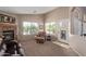 The living room features a stone fireplace, large windows with views, neutral decor and a comfortable seating area at 16280 W Durango St, Goodyear, AZ 85338