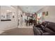 The living room showcases an open floor plan into kitchen, neutral decor, and arched entryway, perfect for modern living at 16280 W Durango St, Goodyear, AZ 85338