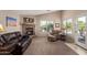 Cozy living room with a stone fireplace, comfortable seating, and a view of the refreshing pool at 16280 W Durango St, Goodyear, AZ 85338