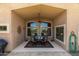 Covered patio with a ceiling fan and a dining table set for four, providing a relaxing outdoor space at 16280 W Durango St, Goodyear, AZ 85338
