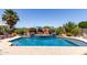 Inviting backyard with a refreshing pool featuring water accents and lush landscaping, ideal for outdoor relaxation at 16280 W Durango St, Goodyear, AZ 85338