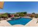 Lush backyard with a beautiful pool featuring water features, surrounded by landscaping, perfect for outdoor enjoyment at 16280 W Durango St, Goodyear, AZ 85338