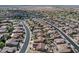 An aerial view showcases rows of homes with desert landscaping, tile roofs, and well-maintained streets in a planned community at 16444 W Chuparosa Ln, Surprise, AZ 85387