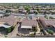 Aerial view of home with a covered patio, desert landscaping, and fenced yard in a well-maintained planned community at 16444 W Chuparosa Ln, Surprise, AZ 85387