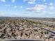 Panoramic aerial view showcases this community with a nearby highway, desert landscaping and mountain backdrop at 16444 W Chuparosa Ln, Surprise, AZ 85387