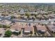 Expansive aerial view of the neighborhood with well-maintained homes and lush desert landscaping in a planned community at 16444 W Chuparosa Ln, Surprise, AZ 85387