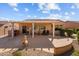 Backyard featuring covered patio, grill, outdoor seating area and desert landscaping at 16444 W Chuparosa Ln, Surprise, AZ 85387