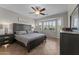 Bedroom with gray wood furniture, large bay window, and tile flooring at 16444 W Chuparosa Ln, Surprise, AZ 85387