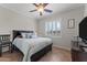 Bedroom with neutral walls, ceiling fan, and plush bedding at 16444 W Chuparosa Ln, Surprise, AZ 85387