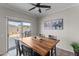 A dining room with a wood table and view through sliding glass door to outdoor grill at 16444 W Chuparosa Ln, Surprise, AZ 85387