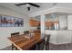 Dining room featuring tile floor, wood table, and view into the kitchen at 16444 W Chuparosa Ln, Surprise, AZ 85387