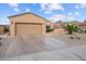 Inviting single-story home with a spacious driveway, two-car garage, and desert landscaping in a well-kept neighborhood at 16444 W Chuparosa Ln, Surprise, AZ 85387