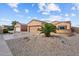 Charming single-story home featuring a three-car garage and desert landscaping at 16444 W Chuparosa Ln, Surprise, AZ 85387