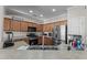 A kitchen featuring stainless steel appliances, wood cabinetry, and neutral countertops at 16444 W Chuparosa Ln, Surprise, AZ 85387