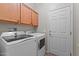Bright laundry room with washer, dryer, and ample cabinet space for storage at 16444 W Chuparosa Ln, Surprise, AZ 85387