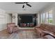 Bright living room with large screen television, comfortable seating and a ceiling fan for a comfortable living space at 16444 W Chuparosa Ln, Surprise, AZ 85387
