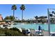 Beautiful pool area with comfortable lounge chairs and well-maintained landscaping creating a relaxing atmosphere at 16444 W Chuparosa Ln, Surprise, AZ 85387