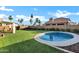 Beautiful backyard with a well-maintained lawn, small pool, and a covered seating area at 16662 S 37Th Way, Phoenix, AZ 85048
