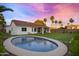 Wide angle of home's backyard, featuring a small pool and well-maintained grass and landscaping at 16662 S 37Th Way, Phoenix, AZ 85048