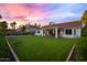 Large backyard with well-maintained lawn, covered patio, and desert landscaping at 16662 S 37Th Way, Phoenix, AZ 85048