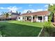 Expansive backyard featuring a lush green lawn and a covered patio with outdoor seating at 16662 S 37Th Way, Phoenix, AZ 85048
