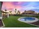 Beautiful backyard featuring a small pool, expansive lawn, and covered seating area at 16662 S 37Th Way, Phoenix, AZ 85048