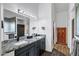 Elegant bathroom features double sinks with granite countertops, dark cabinets, and modern fixtures at 16662 S 37Th Way, Phoenix, AZ 85048