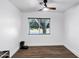 Simple bedroom features a window with blinds and wood-look floors, with a ceiling fan at 16662 S 37Th Way, Phoenix, AZ 85048