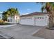 Charming white home with a three-car garage, well-maintained landscaping and a beautiful red tile roof at 16662 S 37Th Way, Phoenix, AZ 85048
