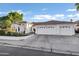 Charming white home with a three-car garage, well-maintained landscaping and a beautiful red tile roof at 16662 S 37Th Way, Phoenix, AZ 85048
