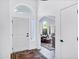 Inviting foyer with white walls and trim, hardwood floors, an archway, and a view of a seating area at 16662 S 37Th Way, Phoenix, AZ 85048