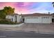 Charming home with a three-car garage, well-manicured lawn, and desert landscaping at 16662 S 37Th Way, Phoenix, AZ 85048