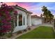 Attractive home featuring an arched entryway, a well-kept lawn, and colorful flowering bushes at 16662 S 37Th Way, Phoenix, AZ 85048