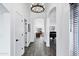Hallway with white trim and walls and dark hardwood flooring leading into an archway with a piano at 16662 S 37Th Way, Phoenix, AZ 85048