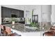 Granite countertop with breakfast bar, stainless steel appliances, and modern dark wood cabinets at 16662 S 37Th Way, Phoenix, AZ 85048