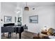 Cozy living room with a piano, chair, and art, accented by modern lighting, and white walls and trim at 16662 S 37Th Way, Phoenix, AZ 85048